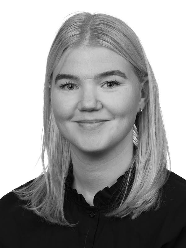 Head-and-shoulders portrait of a smiling woman with blonde hair wearing a black blouse.